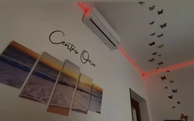 Pared del centro con el nombre Centro Ónix, mariposas y luz rosada
